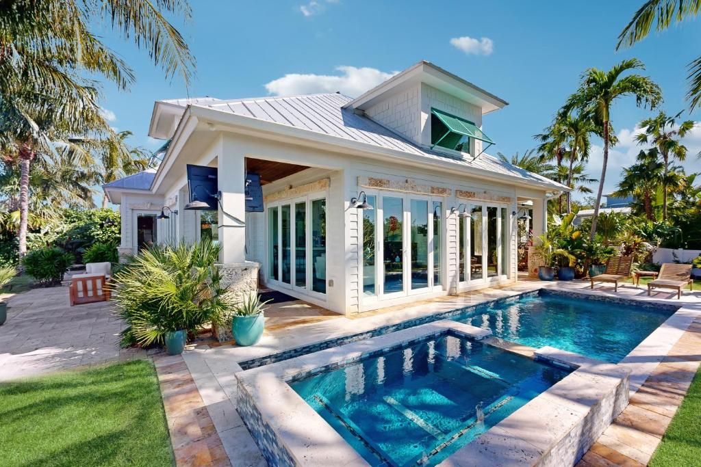 a house with a swimming pool in front of a house at Luxurious Haven in Tavernier