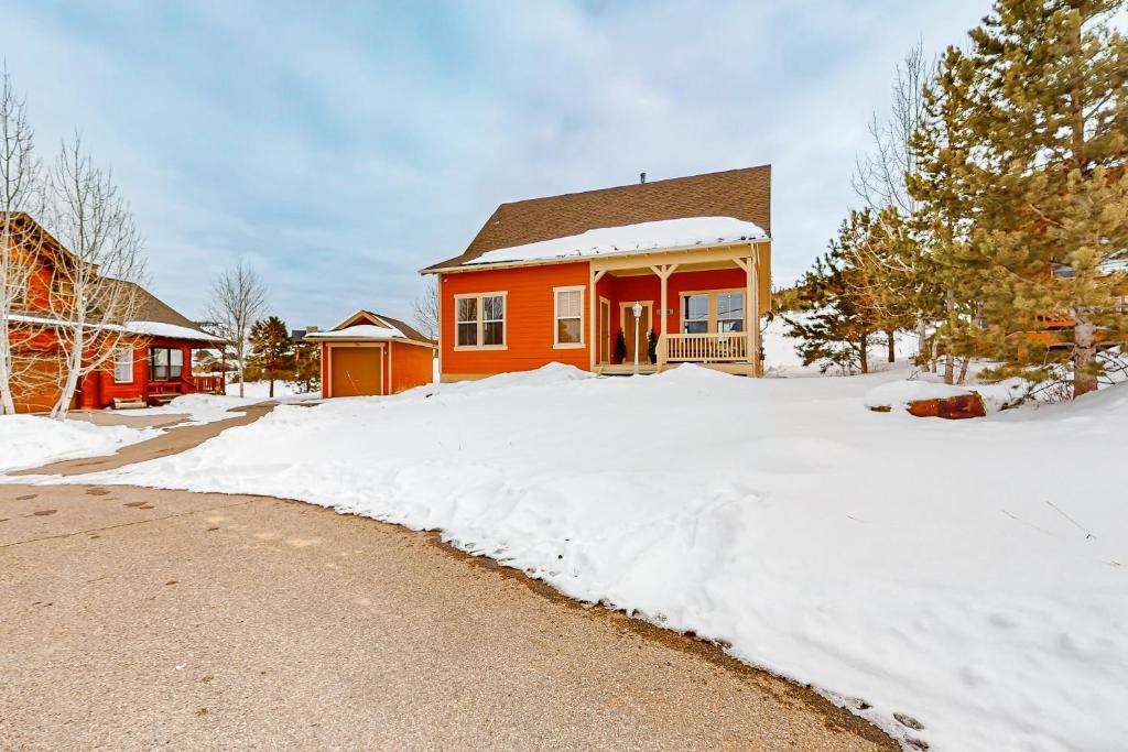 a house with snow in front of a driveway at Tall Timber Getaway in Granby
