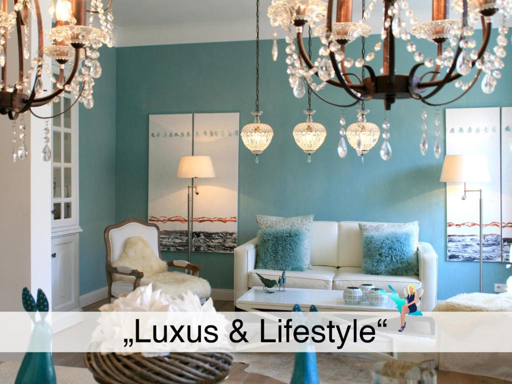 a living room with a couch and a chandelier at Ferienwohnung Luxus & Lifestyle - Luxuriös, exklusiv, traumhaft schön mit Aufzug in Lindau