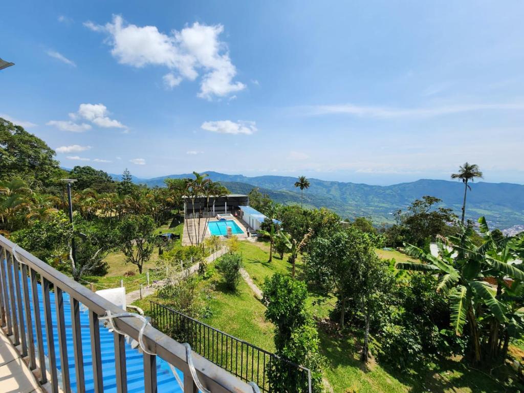 a balcony of a house with a view of the mountains at Hotel Campestre El Refugio in Guaduas