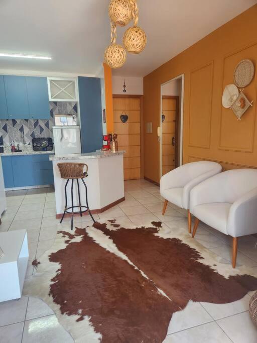 a living room with a map on the floor at Apartamento Capão da Canoa com garagem in Capão da Canoa