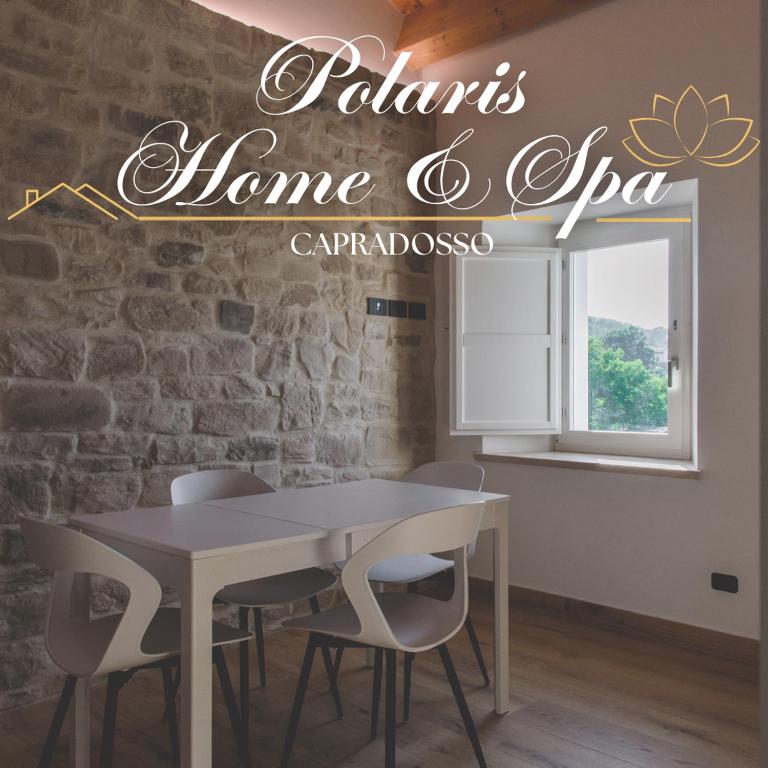 a table and chairs in a room with a brick wall at Tana a 5 STELLE in Capradosso