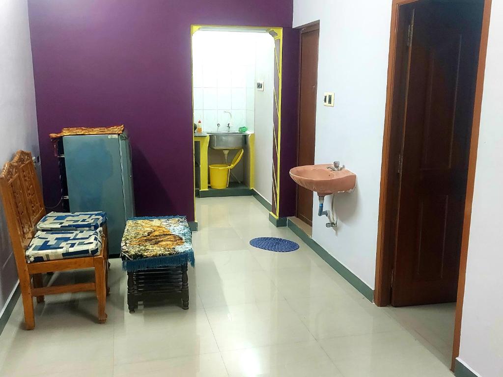 y baño con lavabo, aseo y silla. en casa bon souvenirs, en Pondicherry