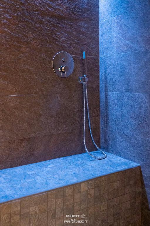 a shower with a shower head in a bathroom at Fior di Roccia Apartments- in centro Cervinia, sauna privata, Matterhorn dream in Breuil-Cervinia