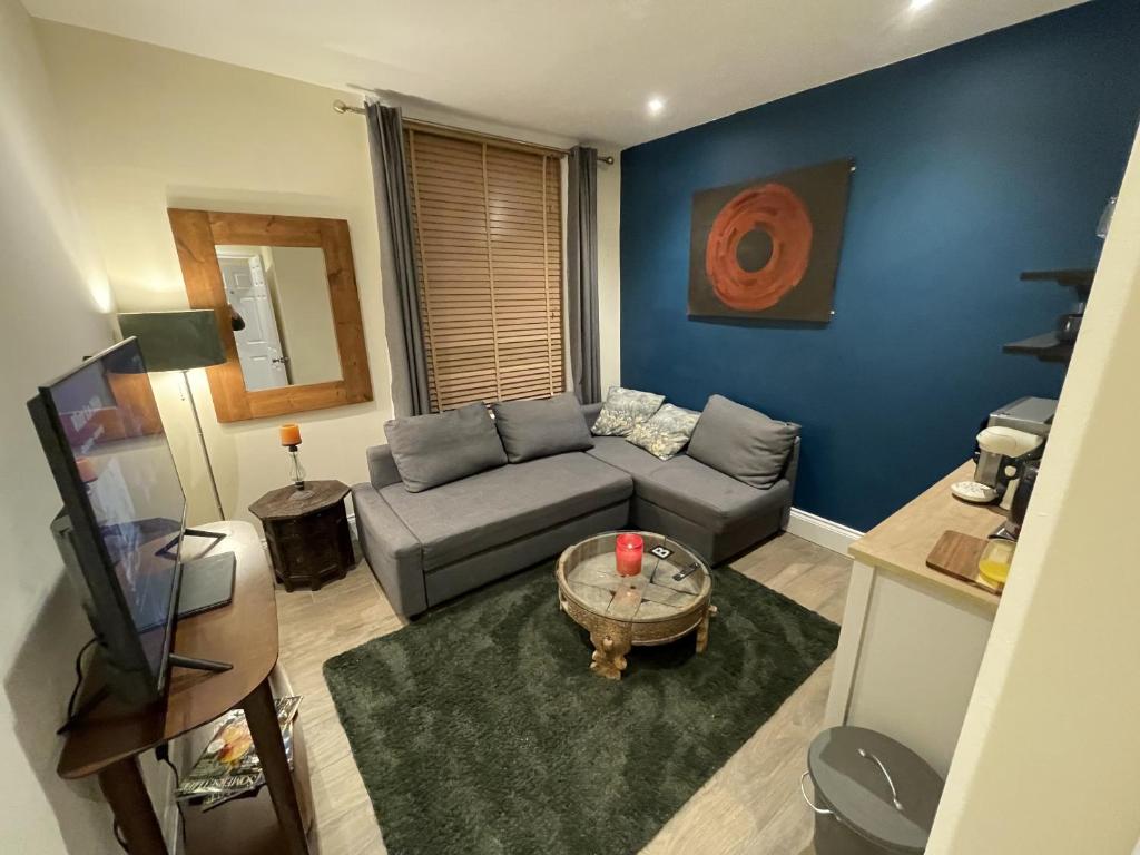 a living room with a couch and a table at Globe Apartments in Glastonbury