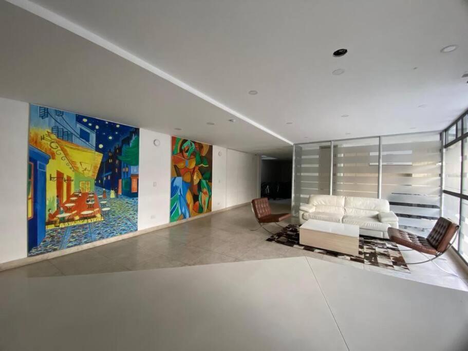 una sala de estar con sofá y una pintura en la pared en Apartamento cerca al Aeropuerto, en Bogotá