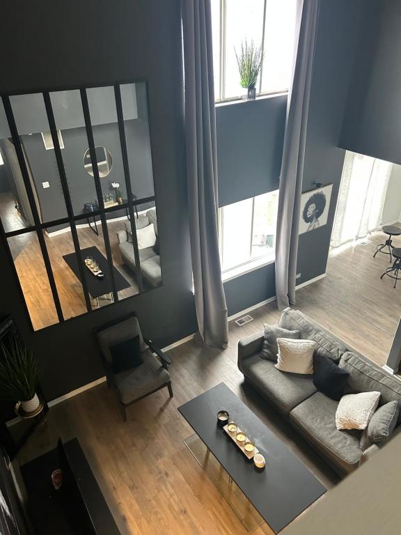 an overhead view of a living room with a couch at Beautiful loft style townhouse-vaulted ceilings in Romeoville