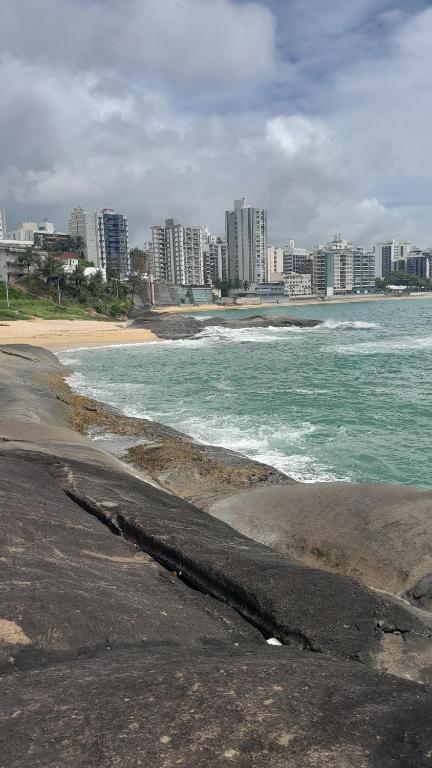 a view of a beach with buildings in the background at EDIF. ELIAS PINTO COELHO, APTO. 304 in Guarapari