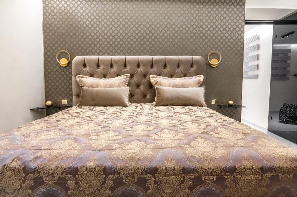 a bedroom with a large bed with a large headboard at Odysseus Luxury House in Rhodes Town