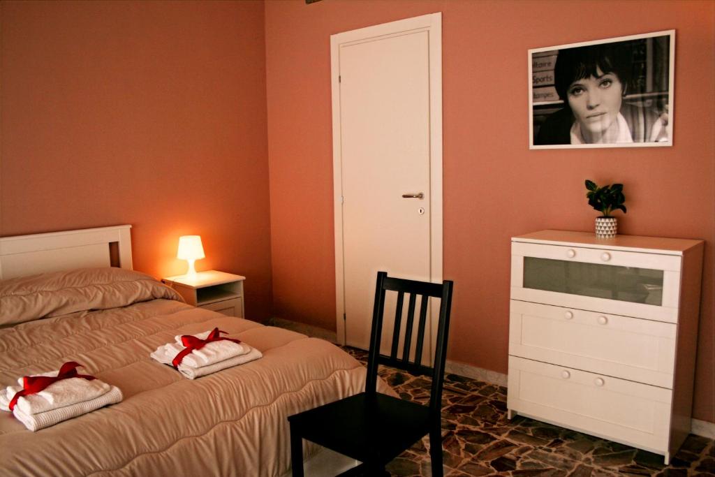 a bedroom with a bed and a dresser and a picture at Dimore Demetra in Canosa di Puglia