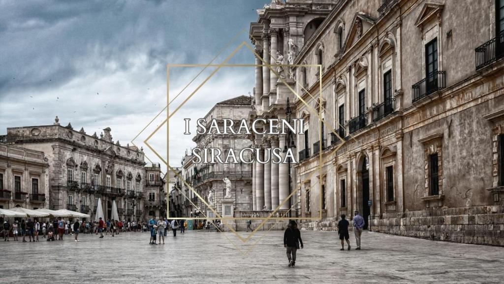 a group of people walking on a street in a city at I SARACENI in Syracuse