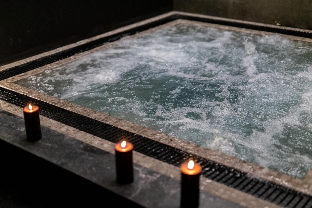 a hot tub with ice and candles in it at La Regalido in Fontvieille
