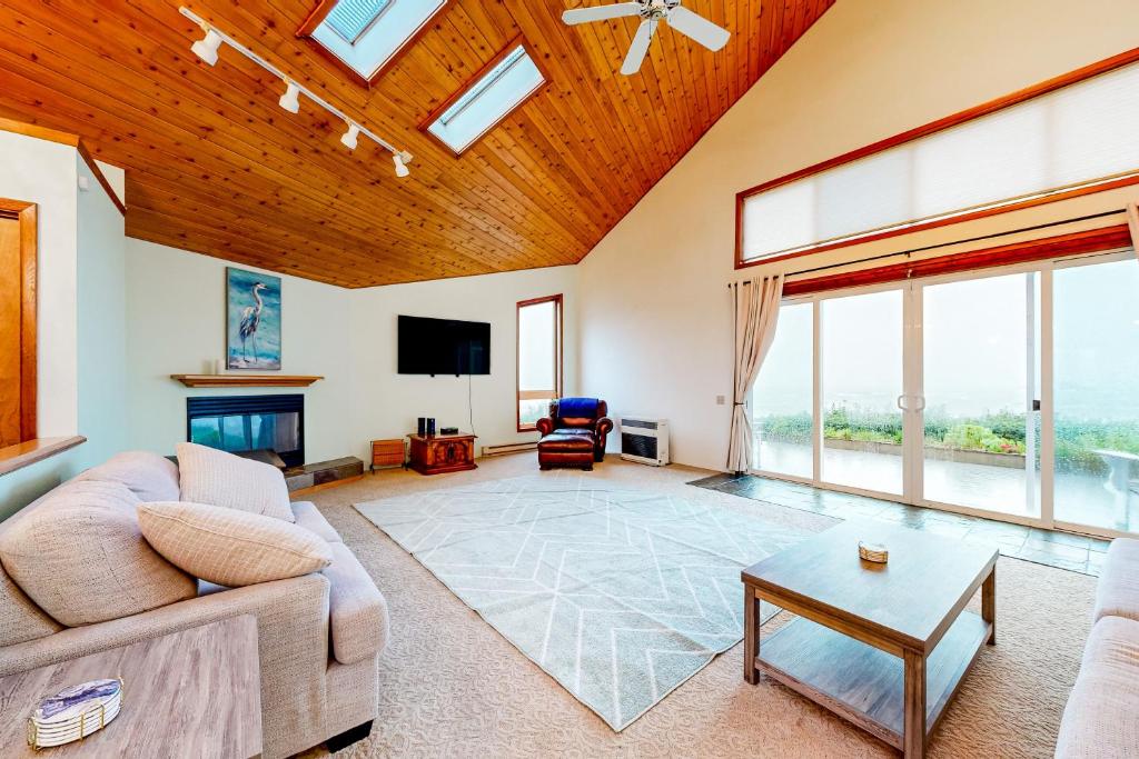 uma sala de estar com um sofá e uma televisão em Pebble Beach Bliss em Crescent City