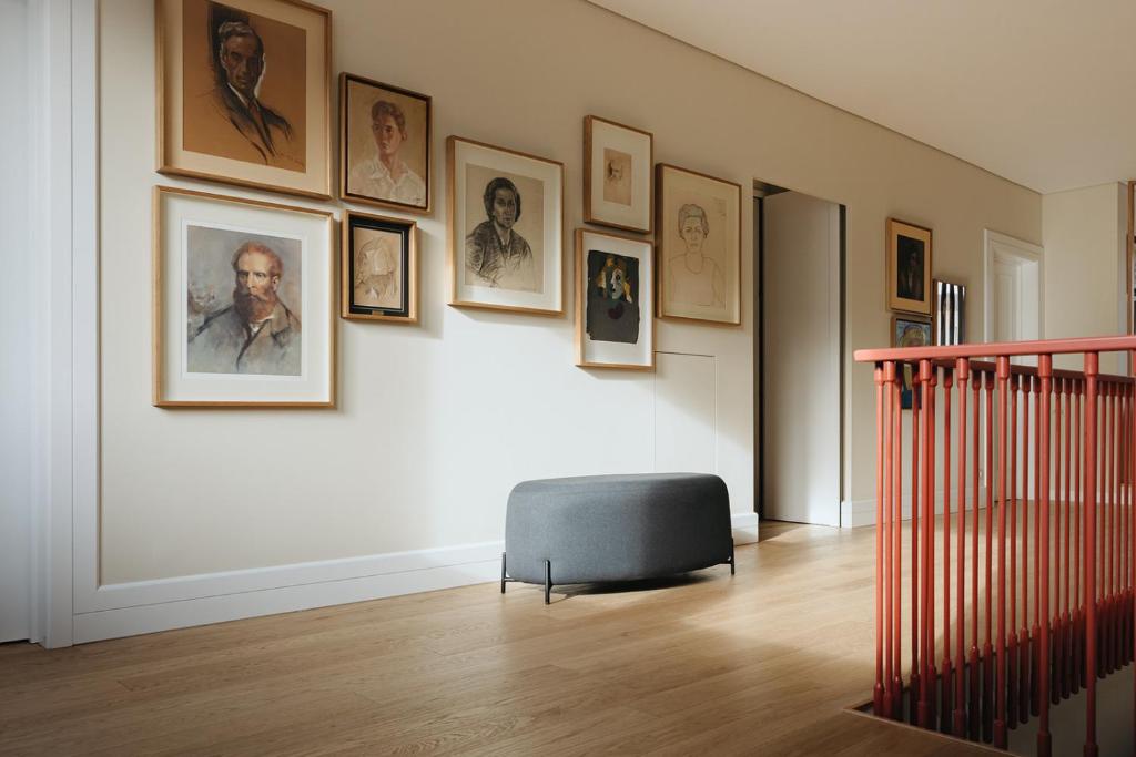 a room with pictures on the wall and a chair at NINE DOTS Azorean Art Boutique Hotel in Ponta Delgada