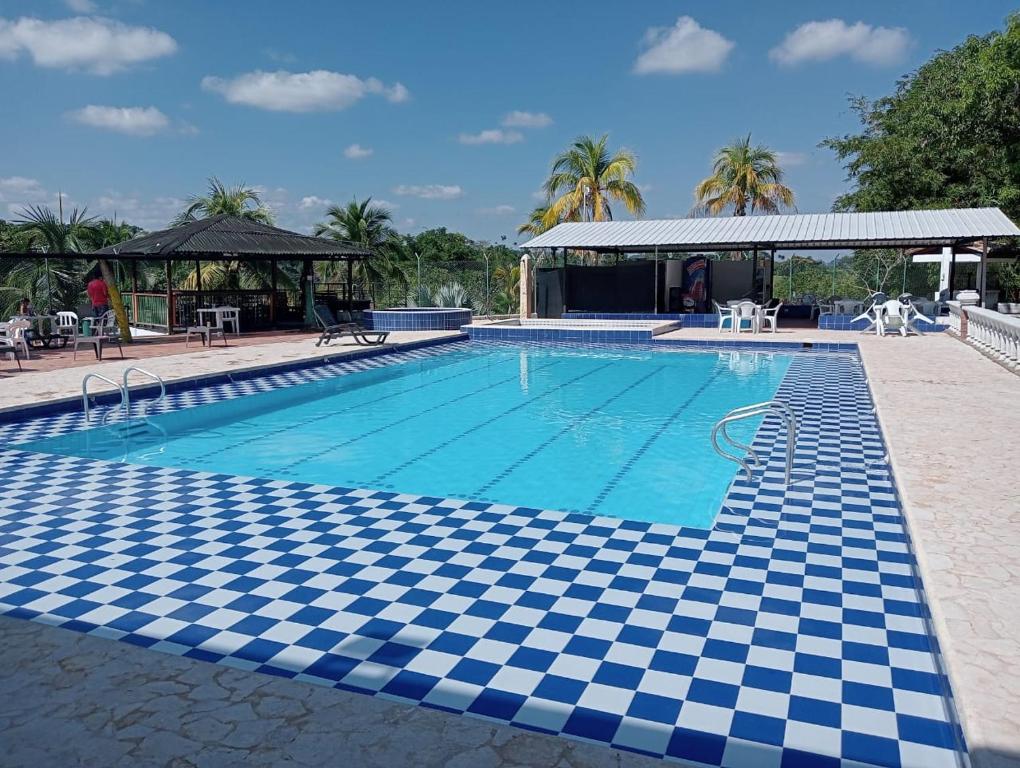 a swimming pool with a checkered floor in a resort at hotel palma dorada in Doradal