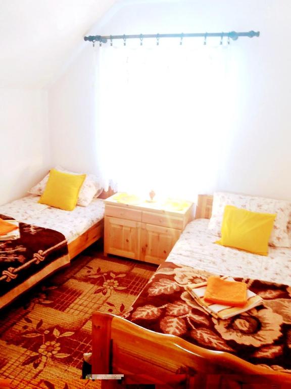 Postel nebo postele na pokoji v ubytování Apartments And Rooms Gold
