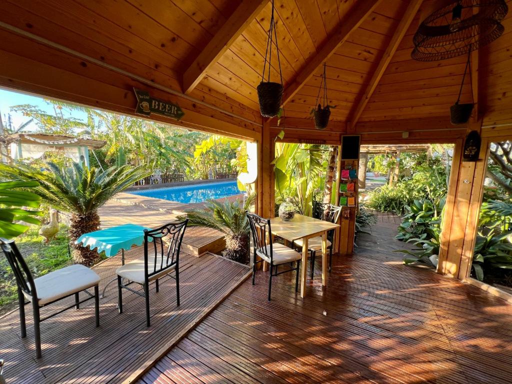 a wooden deck with a table and chairs and a pool at Hotel Altea Paradise 1917 - Adults Only in Altea