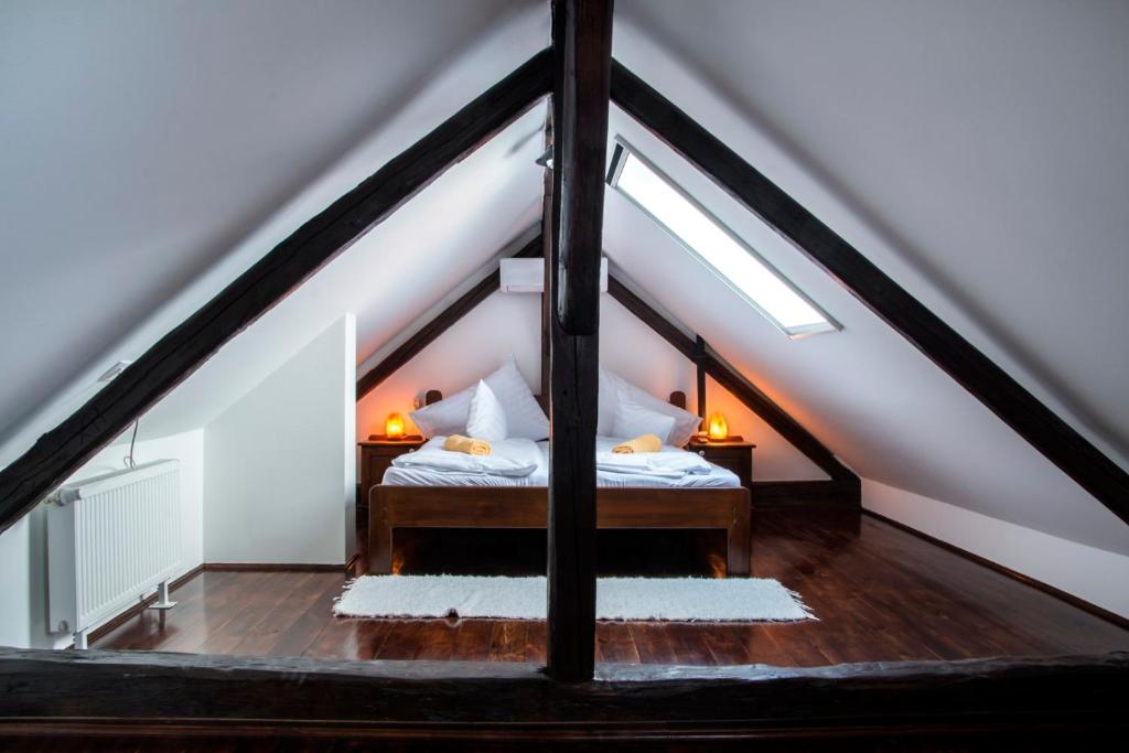 a bedroom with a bed in a attic at SáBa Vendégház in Tapolca