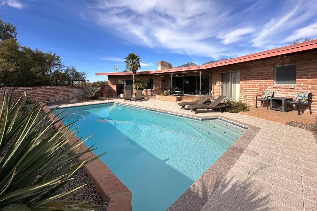 a swimming pool in front of a house at Sierra Vista in Tucson