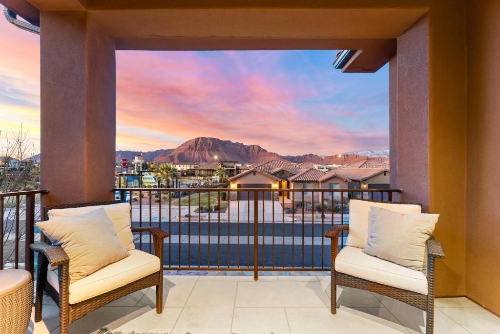 a balcony with two chairs and a view of the mountains at Desert Solitaire #101 in Santa Clara
