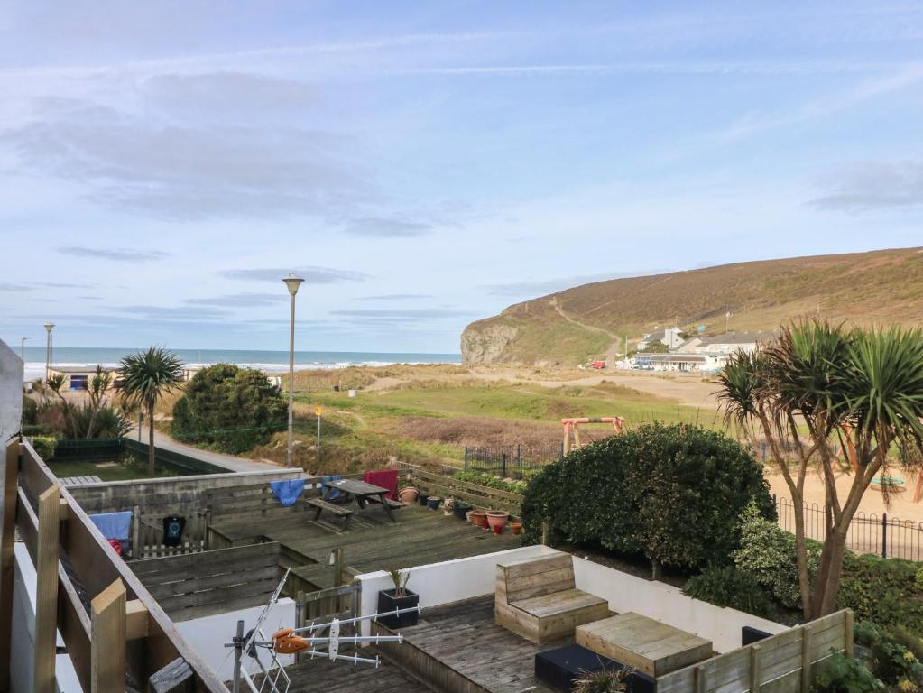 a view of the beach from the balcony of a house at Ocean Blue in Porthtowan