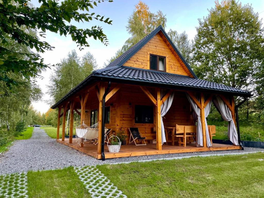 a log cabin with a gambrel roof at Zamojskie Bieszczady in Stary Zamość