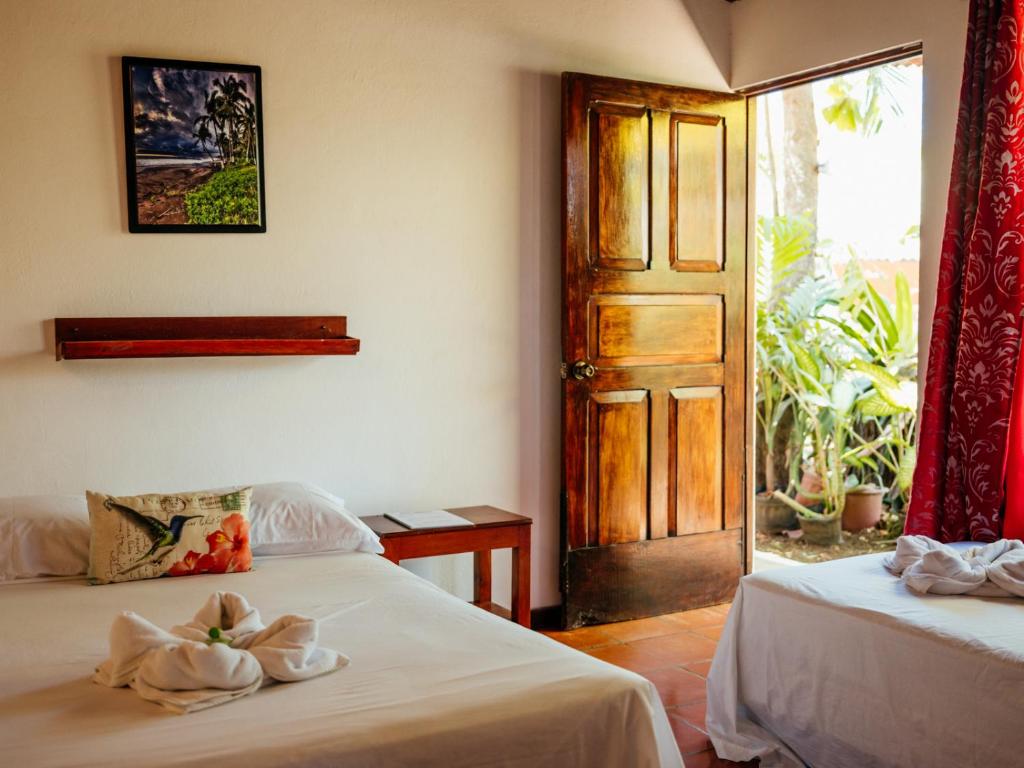 Postel nebo postele na pokoji v ubytování Hotel Hibiscus