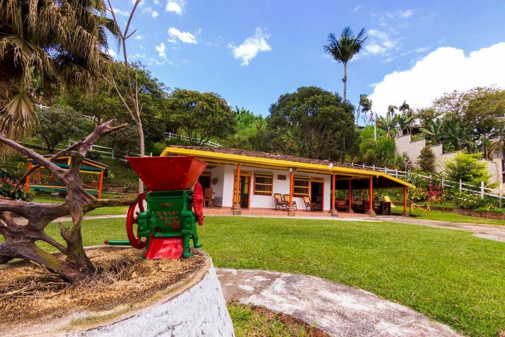 a toy tractor in front of a house at Finca los Juanes in Jardin