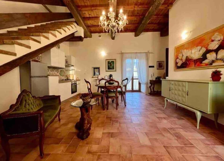 a large living room with a table and chairs at La Casina di Nada in Massa Martana