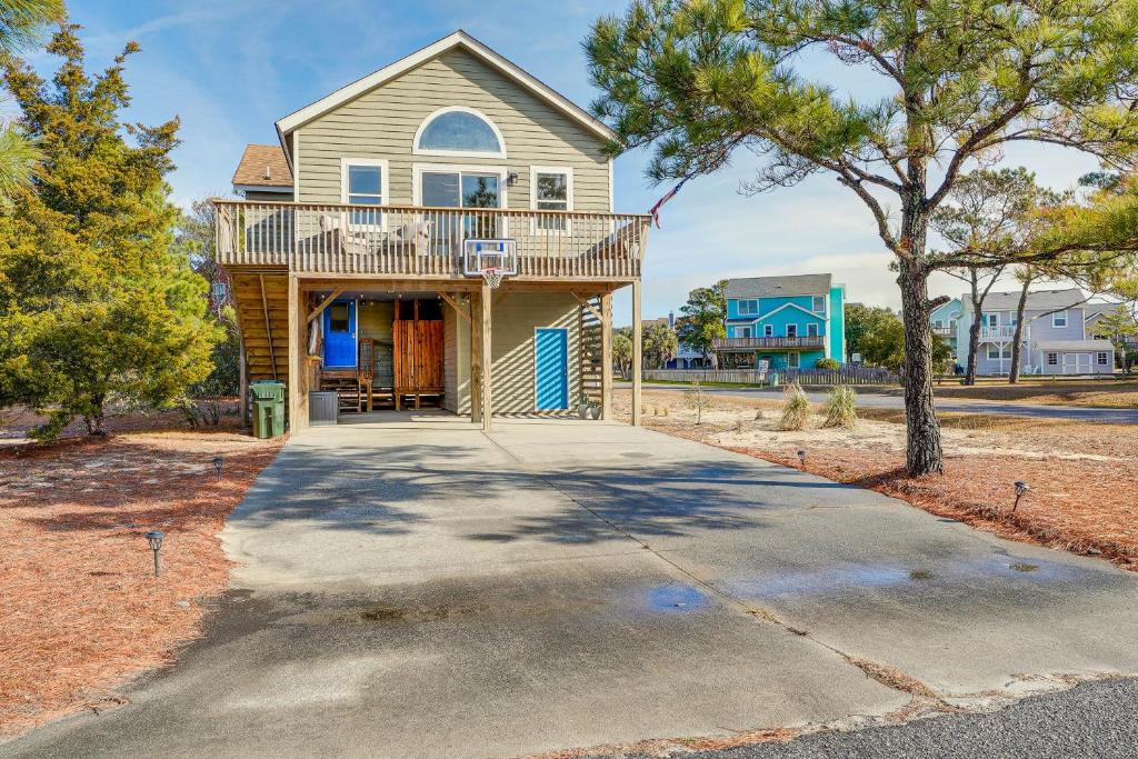 a house with a balcony on a driveway at Charming Nags Head Retreat Half-Mi to State Park! in Nags Head