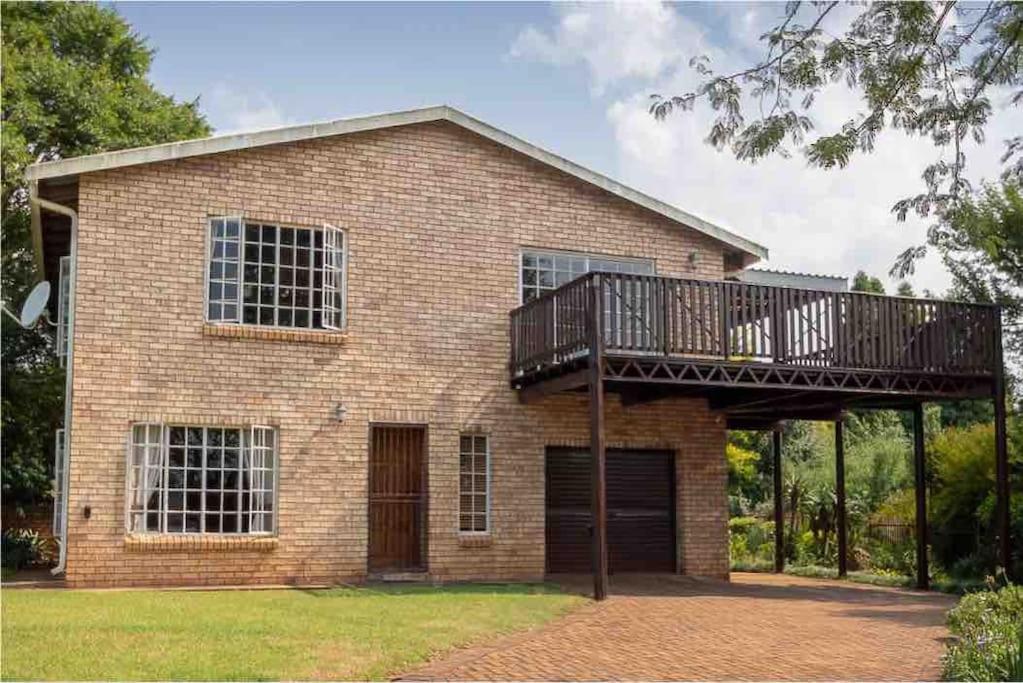 a brick house with a balcony on top of it at Lilly’s-place in Sabie