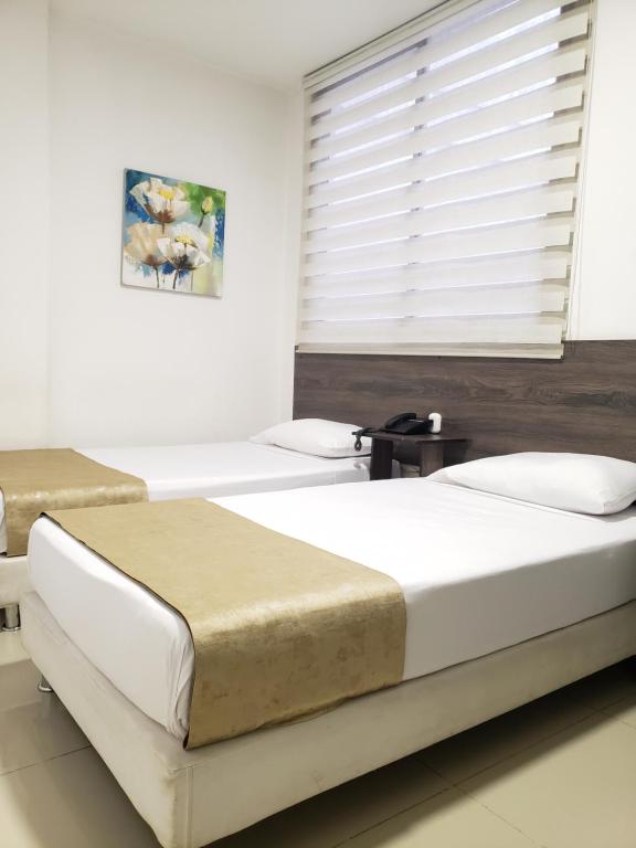 Postel nebo postele na pokoji v ubytování Hotel Suite Center Pereira