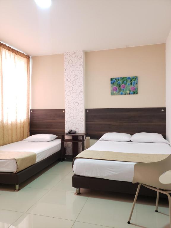 Postel nebo postele na pokoji v ubytování Hotel Suite Center Pereira