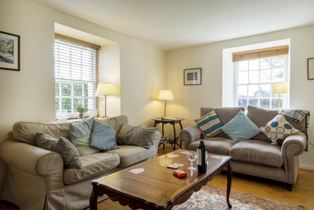 a living room with two couches and a coffee table at White Lodge Haughton Castle 2 in Hexham