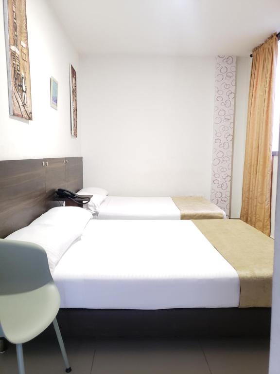 Postel nebo postele na pokoji v ubytování Hotel Suite Center Pereira