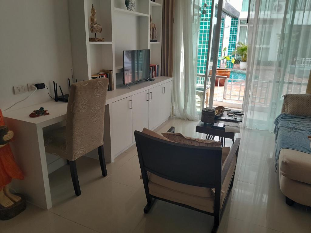 a kitchen with a desk and a table and a chair at Arisara place in Koh Samui
