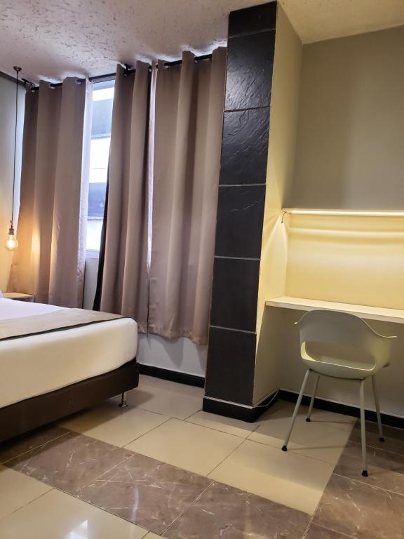 Postel nebo postele na pokoji v ubytování Hotel Suite Center Pereira