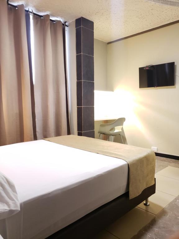 Postel nebo postele na pokoji v ubytování Hotel Suite Center Pereira