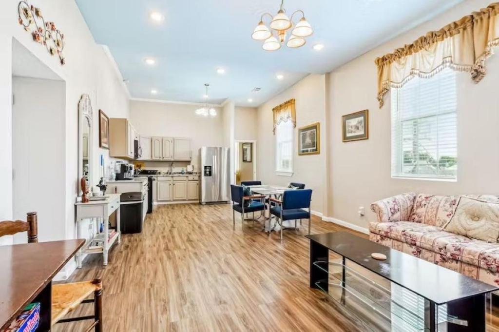 a living room with a couch and a table at Penthouse on Claiborne in New Orleans
