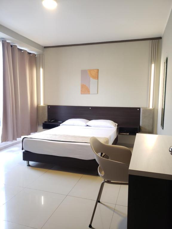 Postel nebo postele na pokoji v ubytování Hotel Suite Center Pereira