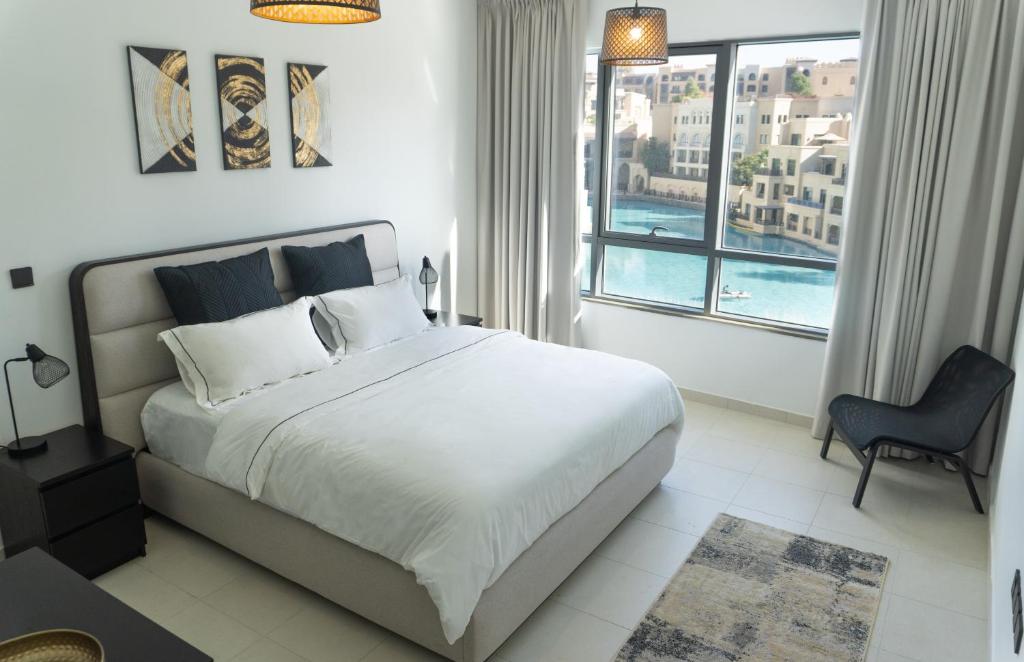 um quarto com uma cama grande e uma janela grande em Downtown Oasis, Burj Khalifa Views, Luxury Amenities em Dubai