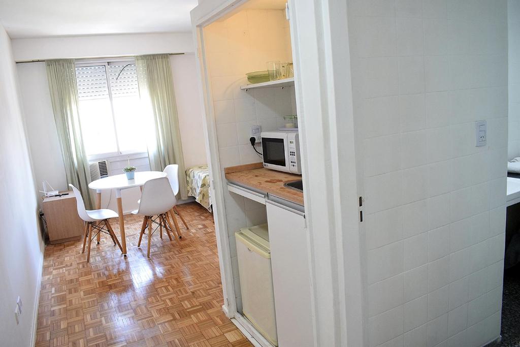 a small kitchen with a table and a microwave at Florida Garden 624 in Buenos Aires
