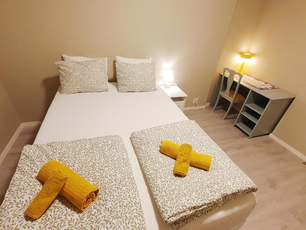 a bedroom with a bed with two crosses on it at Beautiful, convenient, central room 2 in Bergen