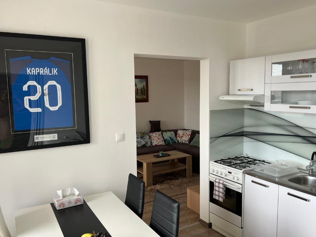 een keuken en een woonkamer met een tafel bij BIG 3 separate rooms convenient City HAVEN ! in Bratislava