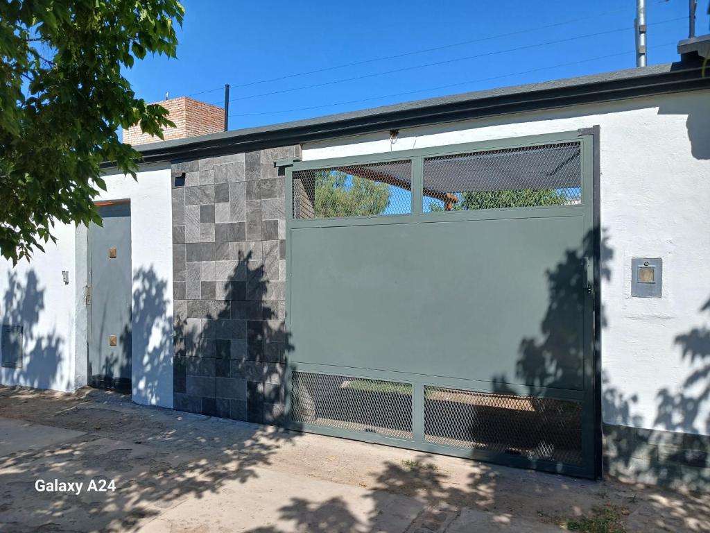 a large white garage door on a building at Alojamiento el Ancla in San Rafael