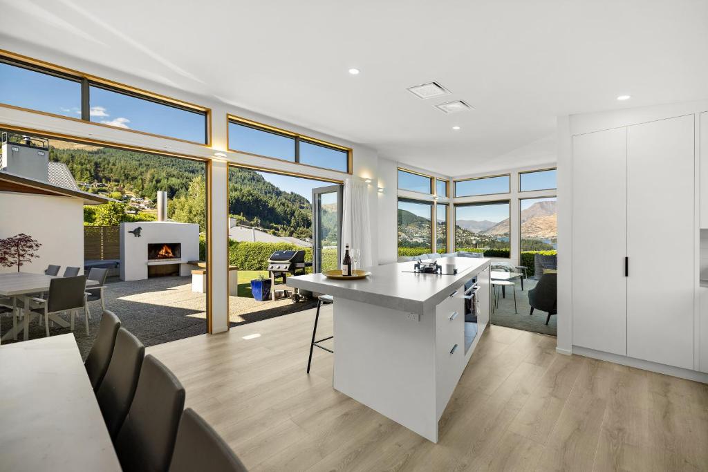 a kitchen and dining room with a view of a house at Whakata on Whitbourn - Luxury Retreat With Spa in Queenstown