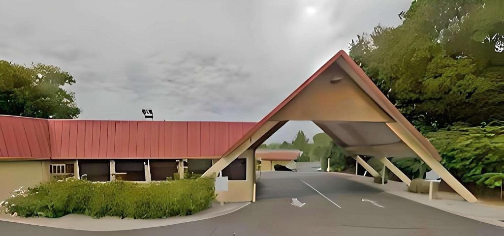 a rendering of a building with a red roof at Econo Lodge in Red Bluff