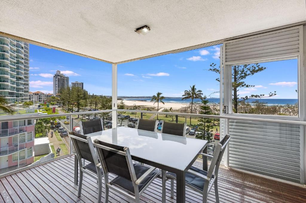 a table and chairs on a balcony with a view of the beach at Sands On Greenmount Unit 4 in Gold Coast