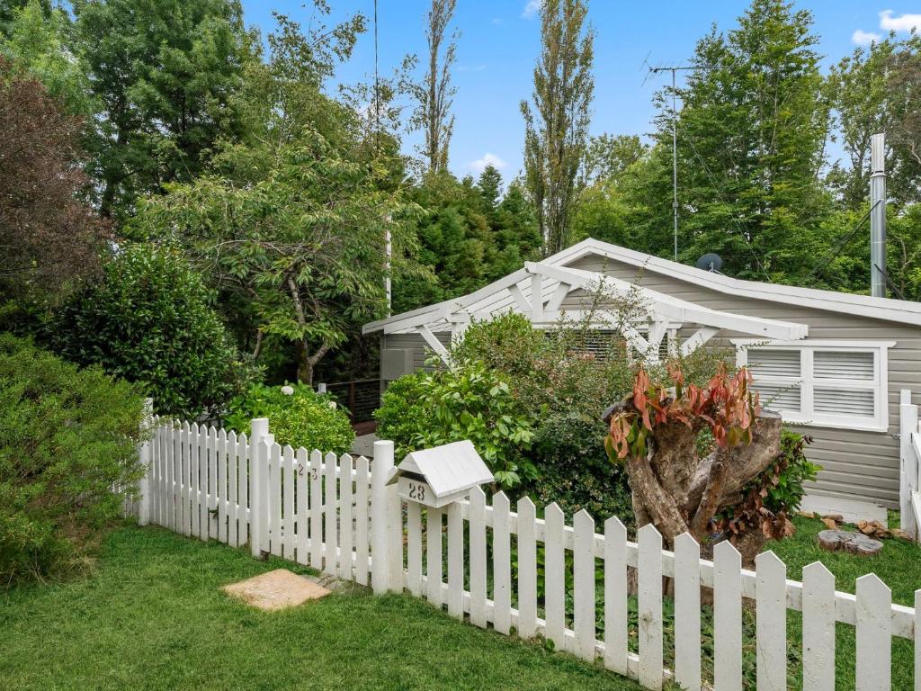 a white picket fence in front of a house at In the Blue in Blackheath