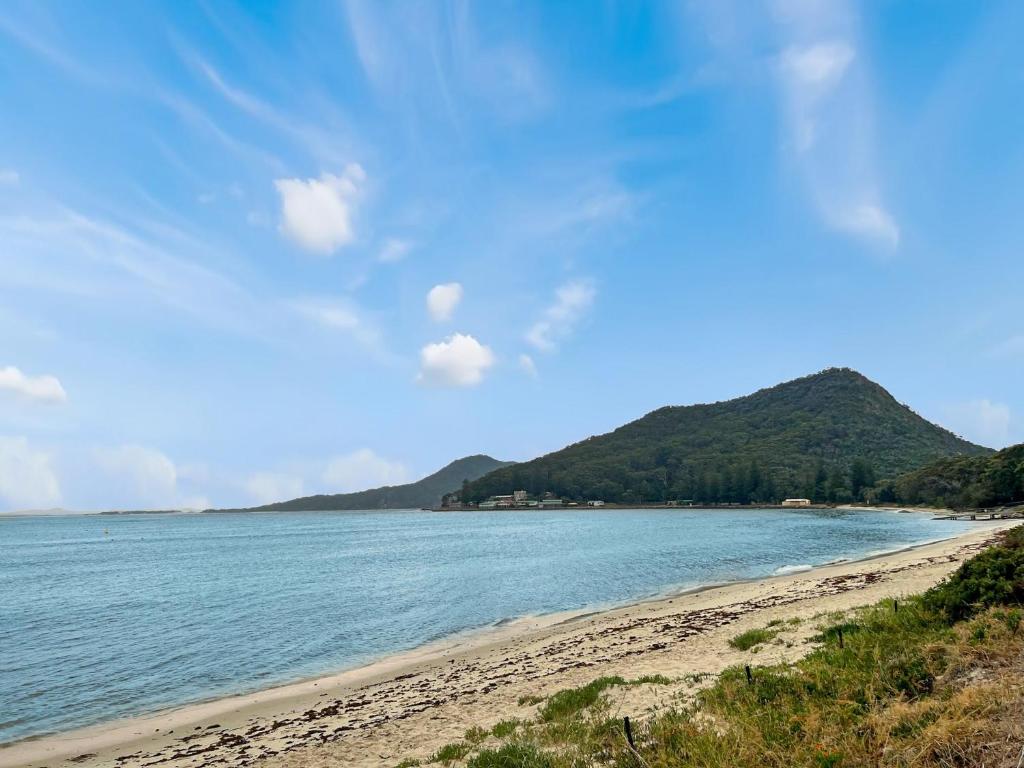 a view of a beach with a mountain in the background at Bella Vista Unit 3 19 Shoal Bay Road in Shoal Bay